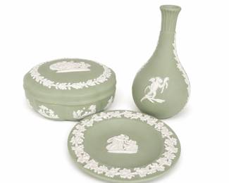 sage green Wedgwood Jasperware set, including a bud vase, a round trinket dish, and a covered box adorned with white classical relief figures