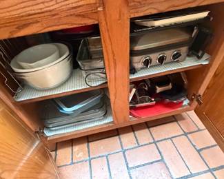 Family of cooks~ cabinets full of kitchen goods