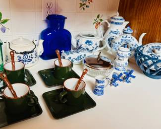 vintage olive green demitasse cups and saucers with matching ceramic spoons With an array of blue and white