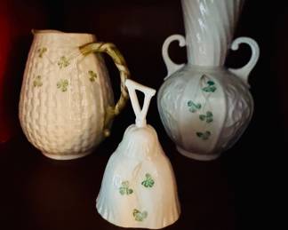 vintage Belleek Porcelain Shamrock Pitcher featuring a textured basketweave body, hand-painted green clover accents, and a branch-style handle