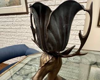 Rare bronze figural stag urn and planter sculpture. Perfect patina curved antlers acting as handles, supporting a flared, petal-like vessel
