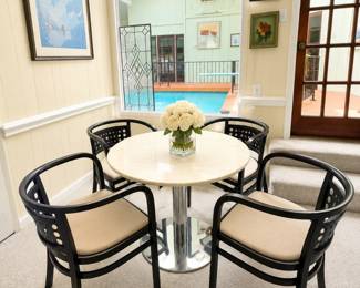 Dinning set featuring four black lacquered bentwood armchairs, that resemble the Postsparkasse design by Otto Wagner for Thonet table with a polished metal pedestal base