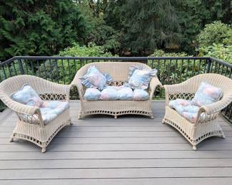 Vintage wicker loveseat and matching chairs — furniture and display pieces are for sale, too.