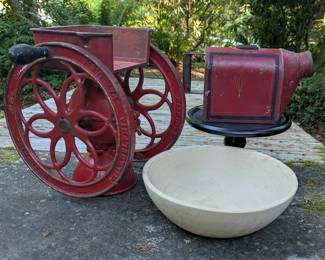 Antique double-wheel coffee grinder with vintage kitchen pieces.