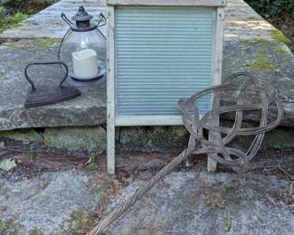 Vintage washboard, rug beater and other old household and utility pieces.
