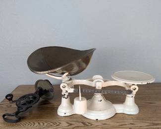 Antique balance scale with iron and kitchen pieces.