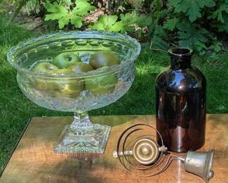 Crystal pedestal bowl, amber glass bottle, vintage store bell and more.