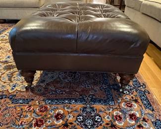 Tufted Leather Ottoman with Turned Legs and Casters