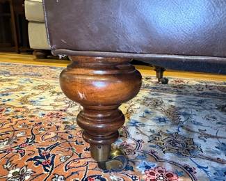 Tufted Leather Ottoman with Turned Legs and Casters