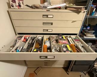 Metal multi-drawer industrial parts cabinet with extensive mixed hardware contents