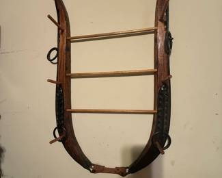 Horse-harness hames converted into a wall-mounted peg rack