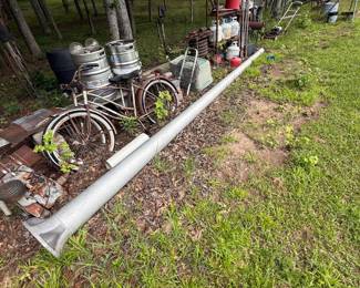 Outdoor salvage group with two cruiser bicycles, beverage kegs, gas cylinders, ducting and assorted equipment - additional view