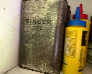 Cabinet group: two mechanical dial scales, branded oil tins, and threaded fittings - additional view