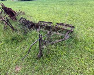 Group of rusted cultivator/plow-type agricultural implements and frames