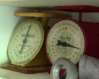 Cabinet group: two mechanical dial scales, branded oil tins, and threaded fittings - additional view