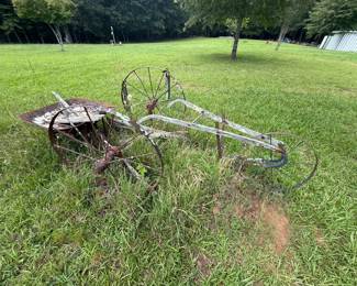 Two overlapping vintage farm implements: wheeled plow and one-wheel cultivator