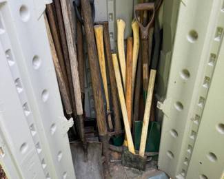 Rubbermaid outdoor storage cabinet with assorted long-handled garden tools