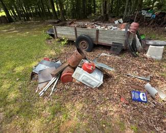 Weathered wood-sided utility trailer with mixed salvage and equipment contents - additional view