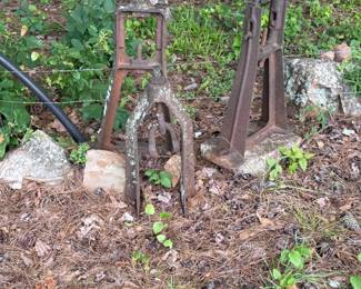 Group of weathered farm implements and mechanical screw jacks