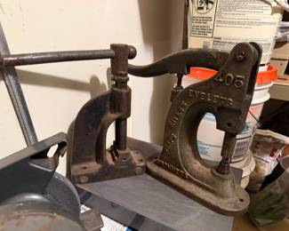 Two vintage cast-iron hand presses, including a marked No. 05 press