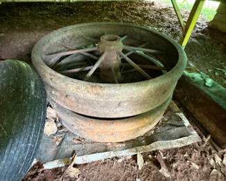 Pair of large metal spoked implement or vehicle wheels