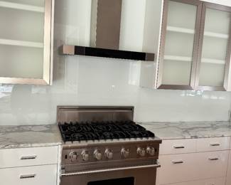 Cabinets either side of range 62” x 24”