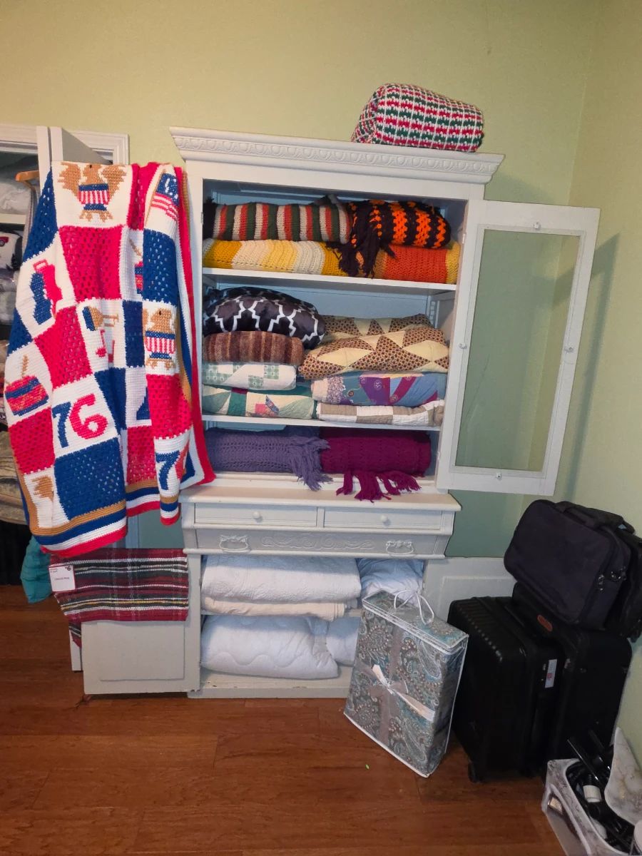 Awesome cabinet filled with quilts, afghans, and linens