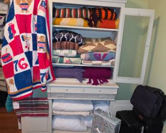 Awesome cabinet filled with quilts, afghans, and linens
