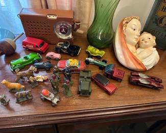 Vintage diecast toy cars, miniature figurines, and decorative ceramic items
