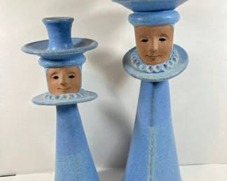 Lot 81: NORTH EAGLE POTTERY - Pair of blue ceramic candle holders with face motifs