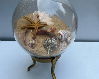 Lot 133: Glass globe sand display with seashells and starfish on brass stand