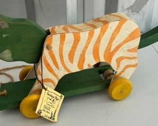 Lot 38: Wooden Zebra-Striped Pull Toy on Green Wheels
