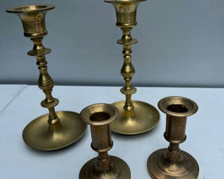 Lot 131: Brass candlesticks and candle holders set