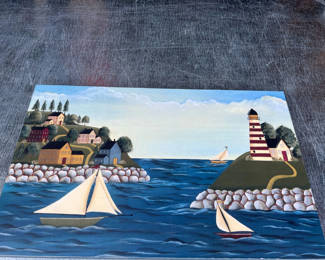 Lot 104: ARTIST SIGNED ON BACK - Coastal Village with Lighthouse and Sailboats 17" x 11"