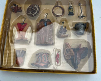 Lot 140: Set of miniature Western clothing and accessories ornaments