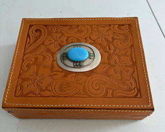 Lot 51: Leather jewelry box with turquoise centerpiece