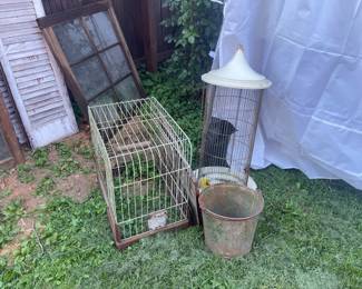 Birds cages, an old bucket, and a closer view of the window and shutters. 