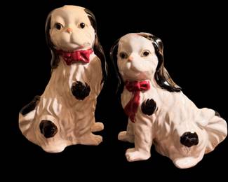 vintage ceramic Staffordshire-style King Charles Spaniel figurine accented with a bright red bow