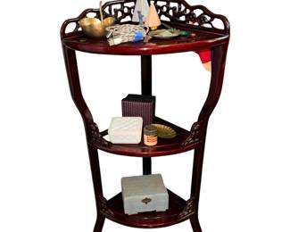 vintage Chinese-style hardwood corner etagere or half-round display stand featuring a rich reddish-brown finish, carved openwork galleries, and three tiered shelves.