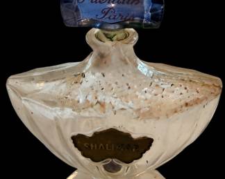 vintage Guerlain Shalimar perfume bottle featuring the iconic "bat-wing" or fan-shaped stopper in blue glass with gold lettering