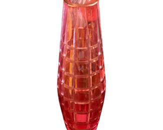  red glass vase with a geometric grid or diamond-cut pattern.