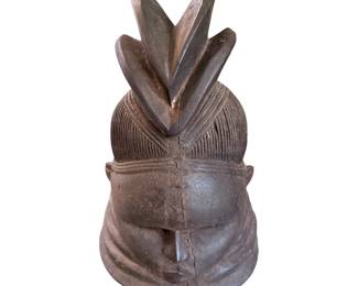 a traditional carved wooden Sowei (or Bundu) helmet mask associated with the women's Sande Society of the Mende people in Sierra Leone and Liberia.