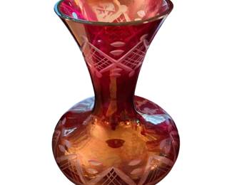 vintage ruby red cut-to-clear glass vase, likely of Bohemian or Czech origin, featuring a flared rim, a bulbous base, and hand-cut geometric and floral accents.