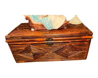 vintage woven bamboo and rattan storage trunk featuring distinctive geometric diamond parquet panels on the front.