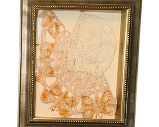 vintage framed textile wall art piece featuring delicate white and orange crocheted lace pinned inside an ornate gold-toned shadow box