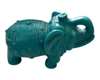 decorative turquoise-colored resin or stone elephant figurine featuring an upturned trunk and etched traditional patterns along its back