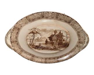 antique brown transferware ceramic serving dish featuring an intricate architectural landscape scene and integrated side handles.