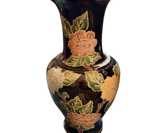 black porcelain floral vase decorated with raised peach and yellow peony motifs and green leaves