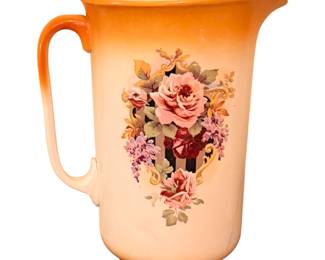 antique ceramic or semi-porcelain pitcher, featuring an orange gradient or luster rim and a detailed pink rose floral transfer design on the front.
