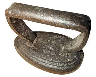 antique child-sized sad iron with a curved or rounded bottom, dating back to the late 19th or early 20th century.